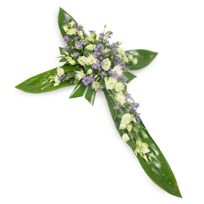 An elegant sympathy cross captured from a slightly elevated view on a plain white field, where every surface and shade reads clearly. The skeletal structure is formed by broad, waxy green tropical leaves, their pronounced veins and glossy sheen shaped into the cross's arms and central spine, creating a calm, verdant framework. Concentrated along the crossing of the arms and trailing gently outward are layers of soft, creamy lisianthus with their layered, ruffled petals and delicate buds, accompanied by clusters of small white chrysanthemums that lend density and luminous highlights. Sprays of tiny lavender or light purple aster/limonium are woven through the white blooms, their pin-point flowers providing a subtle, cooling counterpoint that deepens the arrangement's tonal story. Fine, feathery greenery and tiny filler stems peek between blooms, adding softness and a sense of growth, while the overall lighting bathes the piece evenly, bestowing a gentle radiance reminiscent of an early-morning sky. Texturally, the smooth, protective leaves contrast with the airy, layered petals to create a feeling of sheltering compassion - an intentional design choice for expressions of faith, comfort, and remembrance. This arrangement reads as both traditional and quietly modern, suitable for display at a requiem, wake, or graveside in and around Friern Barnet and neighbouring North Finchley, communicating respect, peace, and the gentle continuity of nature's solace.